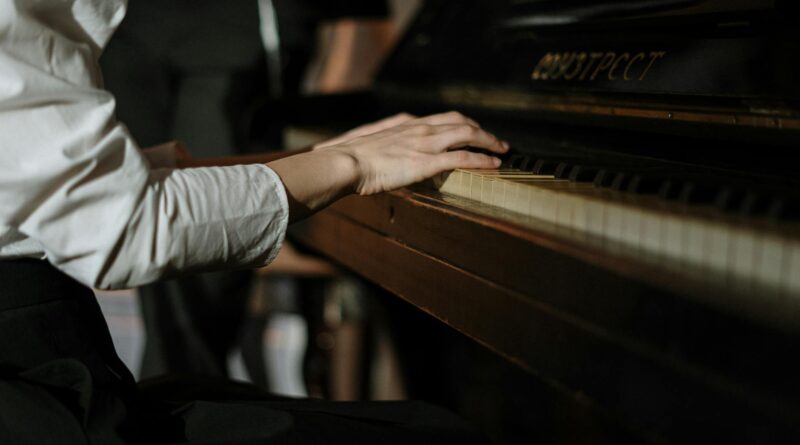 hands sitting music piano
