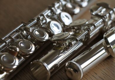 Close-up of a silver-plated flute on a wooden surface