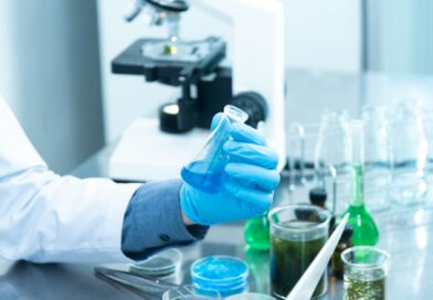 person holding laboratory flask