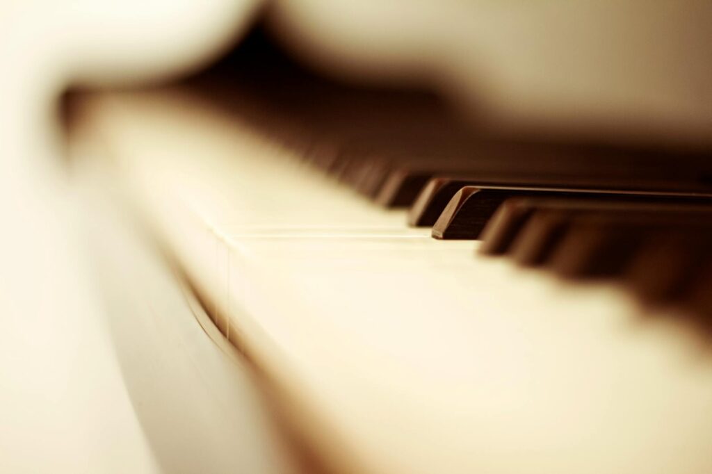 white and black piano keys in blurry photo