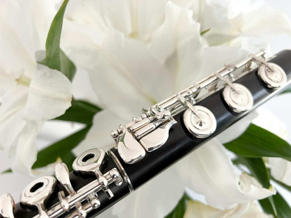 photo of a flute near white lilies