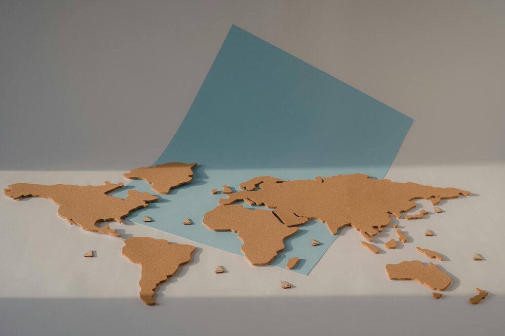 cork world map on blue paper