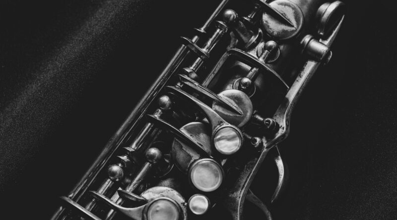 black and silver trumpet on black textile